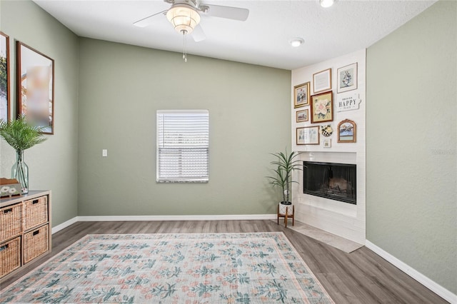 852 Crystal Dr, Palm Harbor, FL 34683 - unfurnished room featuring wood finished floors, a ceiling fan, a fireplace with flush hearth, and recessed lighting