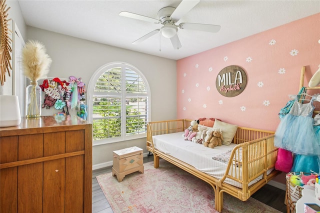 852 Crystal Dr, Palm Harbor, FL 34683 - bedroom with wallpapered walls, light wood-style floors, and a ceiling fan