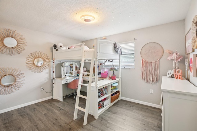 852 Crystal Dr, Palm Harbor, FL 34683 - bedroom with wood finished floors and a textured ceiling