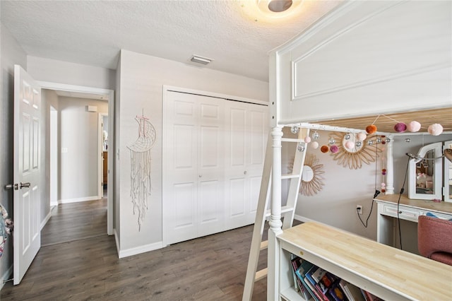 852 Crystal Dr, Palm Harbor, FL 34683 - bedroom featuring wood finished floors, a closet, and a textured ceiling