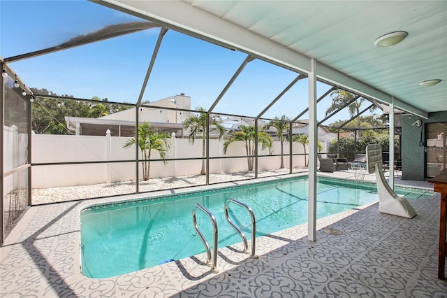 852 Crystal Dr, Palm Harbor, FL 34683 - view of swimming pool featuring a patio area, glass enclosure, and a fenced backyard