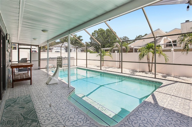 852 Crystal Dr, Palm Harbor, FL 34683 - view of swimming pool featuring a fenced backyard, a patio, and glass enclosure