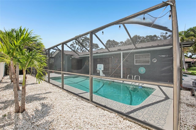 852 Crystal Dr, Palm Harbor, FL 34683 - outdoor pool featuring glass enclosure and a patio area