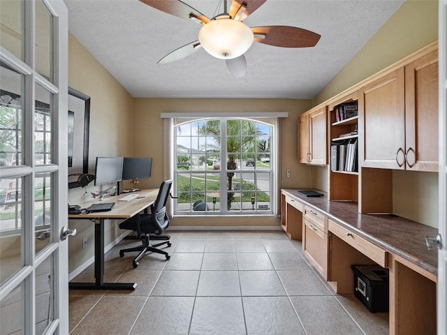 9702 Mary Robin Dr, Riverview, FL 33569 - office with a textured ceiling, ceiling fan, light tile patterned floors, and built in desk