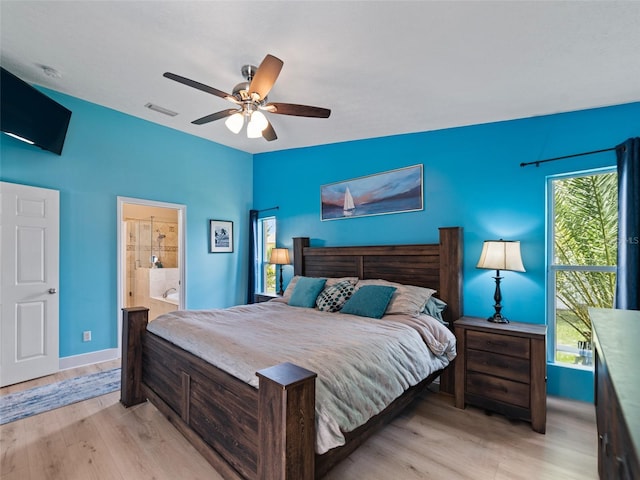 9702 Mary Robin Dr, Riverview, FL 33569 - bedroom featuring light wood-style floors, ceiling fan, and connected bathroom