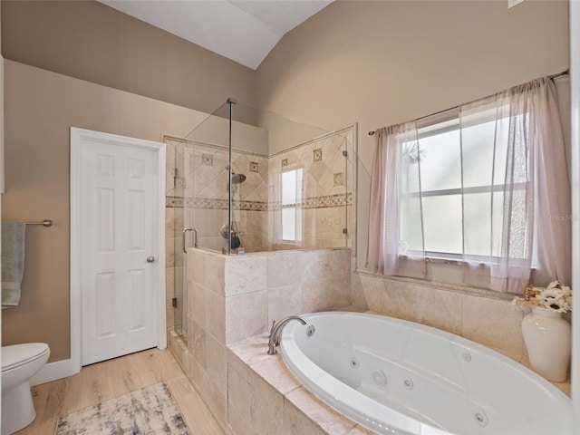 9702 Mary Robin Dr, Riverview, FL 33569 - bathroom featuring a shower stall, a tub with jets, vaulted ceiling, and wood finished floors