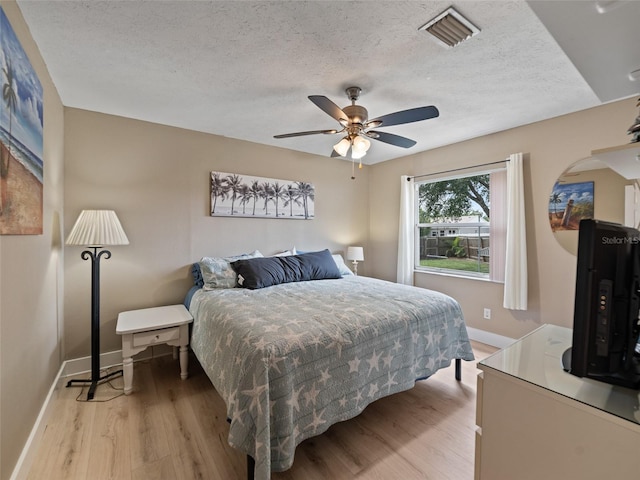 9702 Mary Robin Dr, Riverview, FL 33569 - bedroom featuring a textured ceiling, light wood finished floors, and a ceiling fan