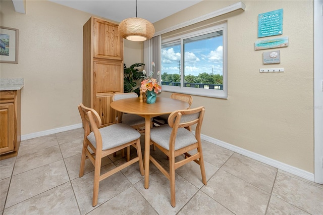 8584 111th St Unit 308, Seminole, FL 33772 - dining room featuring baseboards and light tile patterned flooring