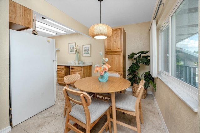 8584 111th St Unit 308, Seminole, FL 33772 - dining area featuring light tile patterned floors and baseboards