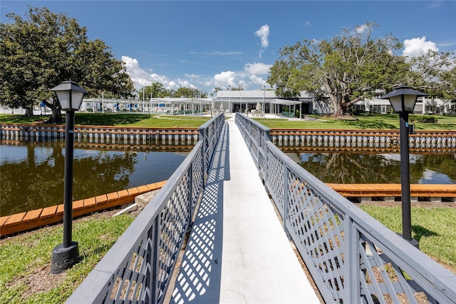 8584 111th St Unit 308, Seminole, FL 33772 - dock area featuring a water view and a yard