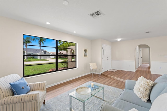 4530 Zack Dr, New Port Richey, FL 34653 - living room with arched walkways, wainscoting, wood finished floors, and recessed lighting