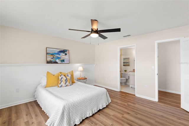 4530 Zack Dr, New Port Richey, FL 34653 - bedroom with wood finished floors, connected bathroom, and a ceiling fan