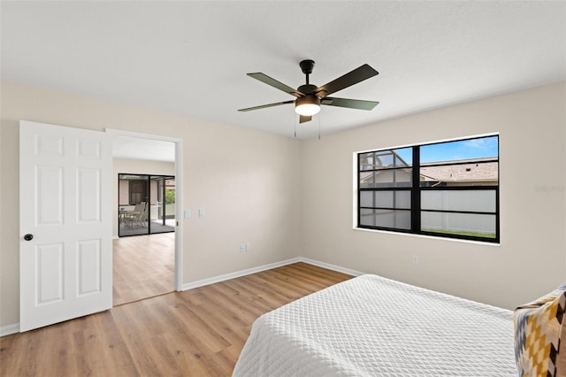 4530 Zack Dr, New Port Richey, FL 34653 - bedroom with multiple windows, wood finished floors, and ceiling fan