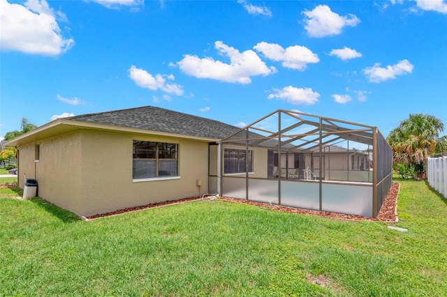 4530 Zack Dr, New Port Richey, FL 34653 - back of property featuring stucco siding, a shingled roof, and glass enclosure