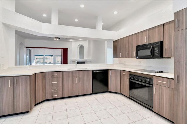 211 Arlington Ave E, Oldsmar, FL 34677 - kitchen featuring black appliances, light countertops, recessed lighting, and modern cabinets