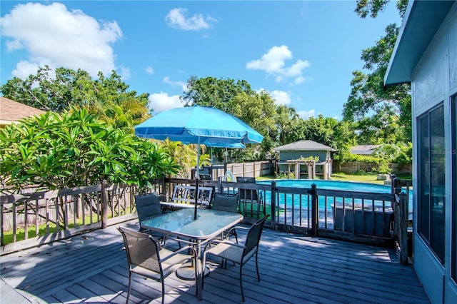 211 Arlington Ave E, Oldsmar, FL 34677 - deck with outdoor dining space, a fenced backyard, and an outbuilding