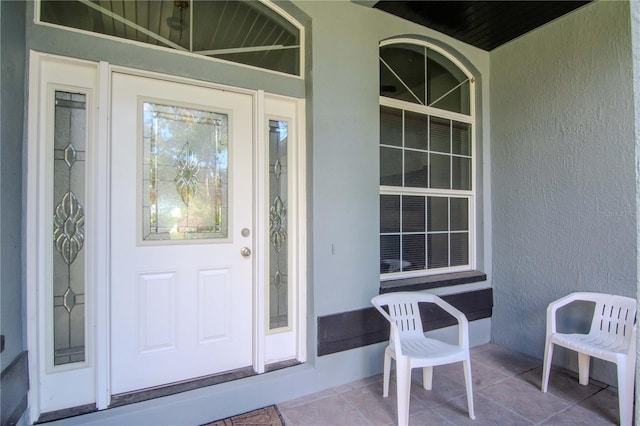 211 Arlington Ave E, Oldsmar, FL 34677 - doorway to property with covered porch and stucco siding