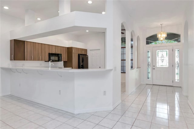 211 Arlington Ave E, Oldsmar, FL 34677 - entryway featuring light tile patterned flooring, recessed lighting, a chandelier, and arched walkways