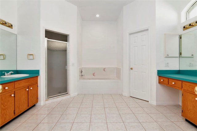 211 Arlington Ave E, Oldsmar, FL 34677 - bathroom with vanity, a garden tub, a shower stall, and tile patterned floors