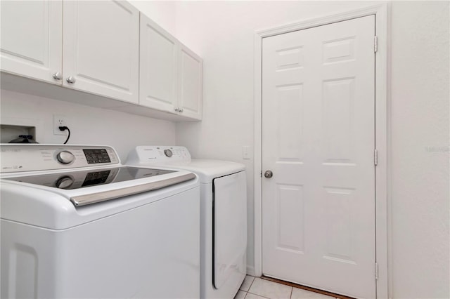 211 Arlington Ave E, Oldsmar, FL 34677 - washroom with washer and dryer, cabinet space, and light tile patterned flooring