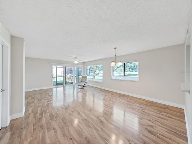 700 Starkey Rd Unit 311, Largo, FL 33771 - unfurnished living room featuring light wood-style floors, a textured ceiling, and ceiling fan