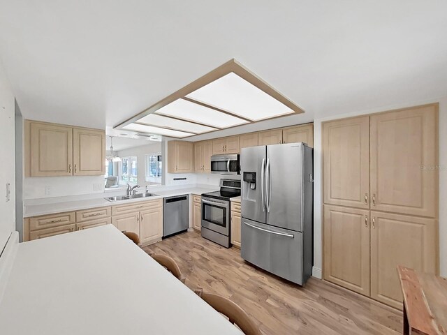 700 Starkey Rd Unit 311, Largo, FL 33771 - kitchen with stainless steel appliances, light brown cabinets, light wood finished floors, and light countertops