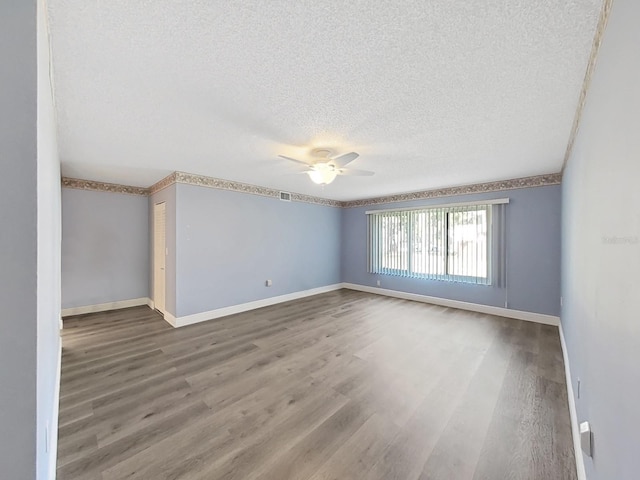 700 Starkey Rd Unit 311, Largo, FL 33771 - unfurnished room with a ceiling fan, a textured ceiling, and wood finished floors