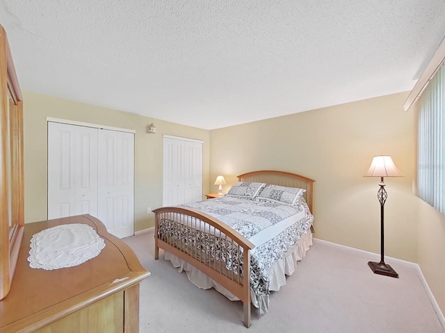700 Starkey Rd Unit 311, Largo, FL 33771 - bedroom with multiple closets, carpet floors, and a textured ceiling
