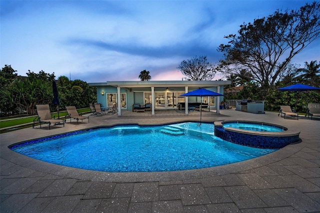 4381 Poinsettia Dr, St Pete Beach, FL 33706 - pool at dusk featuring a patio and a pool with connected hot tub