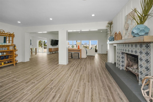4381 Poinsettia Dr, St Pete Beach, FL 33706 - living room featuring light wood finished floors, a fireplace, and recessed lighting