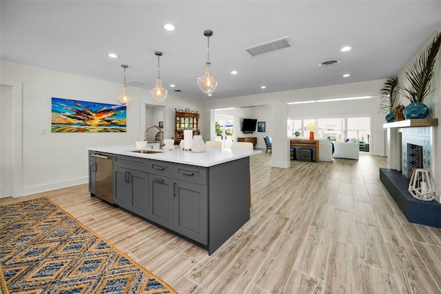 4381 Poinsettia Dr, St Pete Beach, FL 33706 - kitchen featuring stainless steel dishwasher, gray cabinets, open floor plan, light countertops, and recessed lighting
