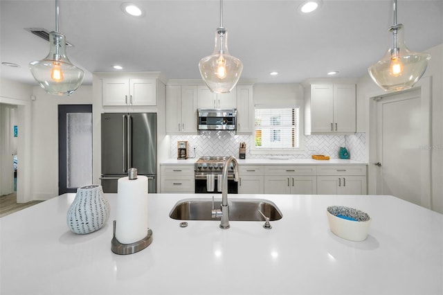 4381 Poinsettia Dr, St Pete Beach, FL 33706 - kitchen featuring stainless steel appliances, light countertops, backsplash, white cabinets, and recessed lighting