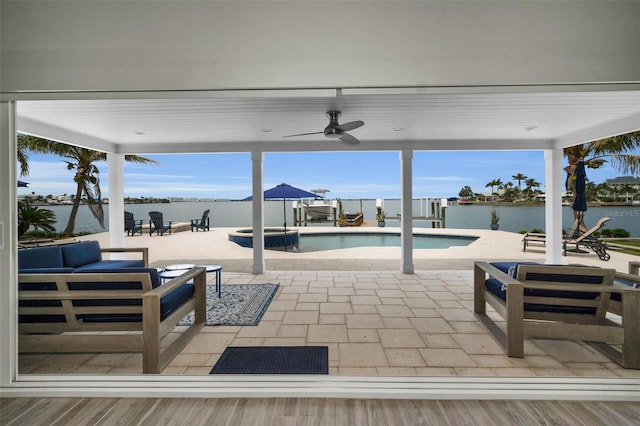 4381 Poinsettia Dr, St Pete Beach, FL 33706 - view of patio with outdoor lounge area, a pool with connected hot tub, ceiling fan, and a water view