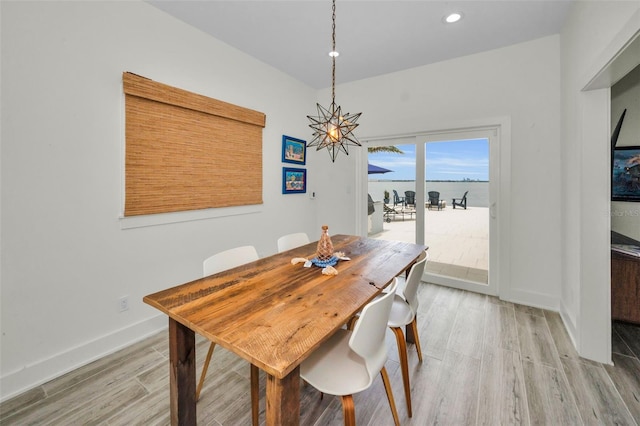 4381 Poinsettia Dr, St Pete Beach, FL 33706 - dining space with light wood-type flooring, a chandelier, recessed lighting, and a water view