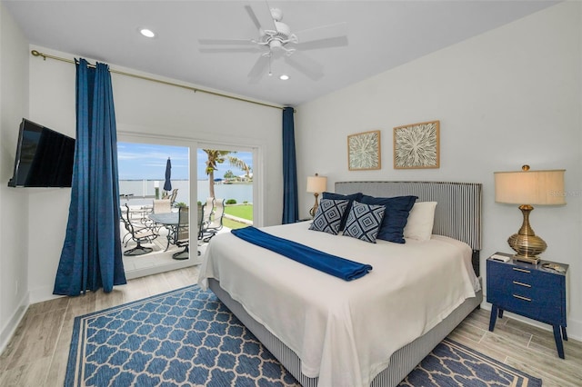 4381 Poinsettia Dr, St Pete Beach, FL 33706 - bedroom featuring a water view, access to outside, wood finished floors, recessed lighting, and ceiling fan
