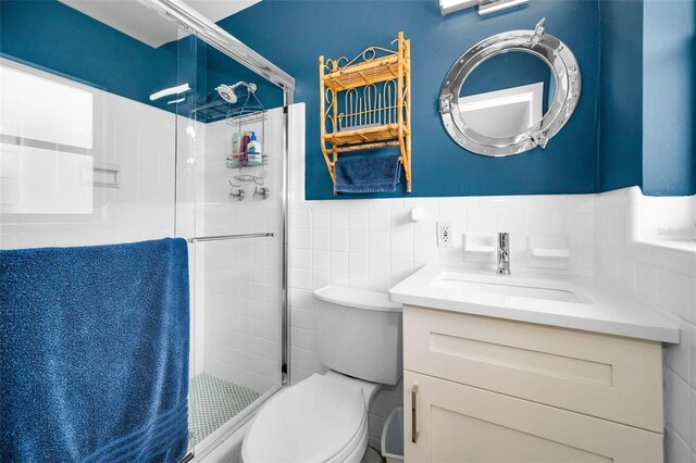 4381 Poinsettia Dr, St Pete Beach, FL 33706 - full bathroom featuring vanity, a shower stall, tile walls, and wainscoting