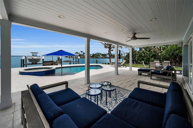 4381 Poinsettia Dr, St Pete Beach, FL 33706 - view of patio / terrace with boat lift, a water view, a ceiling fan, and a pool with connected hot tub