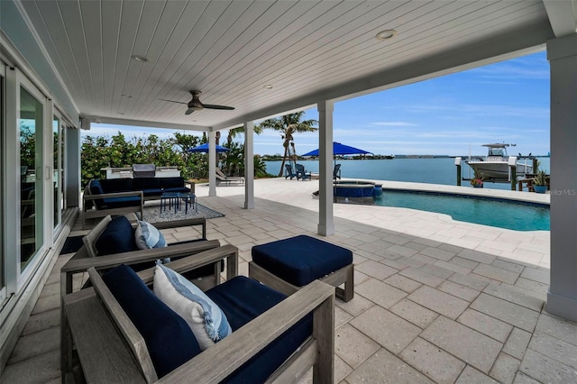 4381 Poinsettia Dr, St Pete Beach, FL 33706 - view of patio / terrace featuring a water view, boat lift, a pool with connected hot tub, outdoor lounge area, and a ceiling fan
