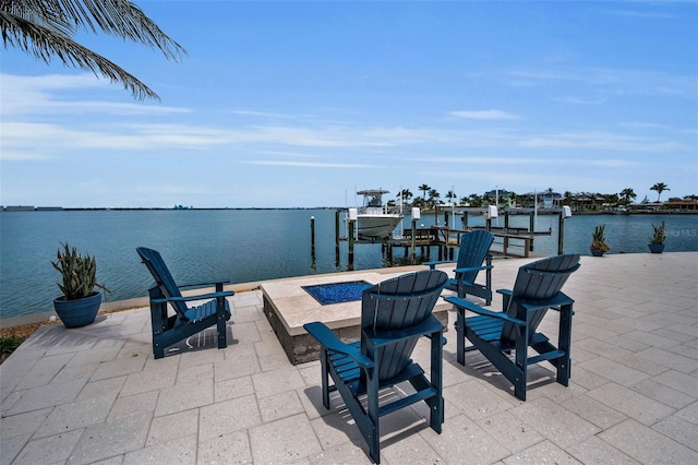 4381 Poinsettia Dr, St Pete Beach, FL 33706 - view of patio / terrace featuring boat lift, a dock, a fire pit, and a water view