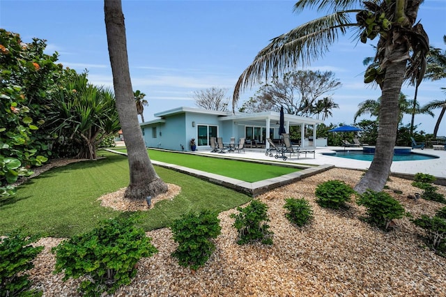 4381 Poinsettia Dr, St Pete Beach, FL 33706 - rear view of property with a patio, an outdoor pool, and stucco siding