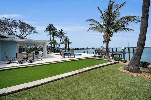 4381 Poinsettia Dr, St Pete Beach, FL 33706 - dock area featuring a water view, a patio, a lawn, and a swimming pool