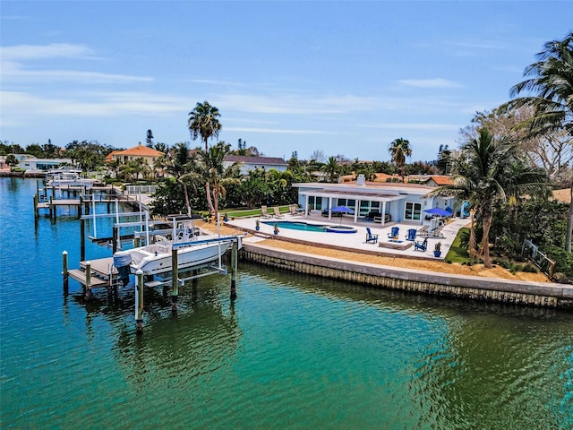 4381 Poinsettia Dr, St Pete Beach, FL 33706 - dock with boat lift, a patio area, a water view, and an outdoor pool