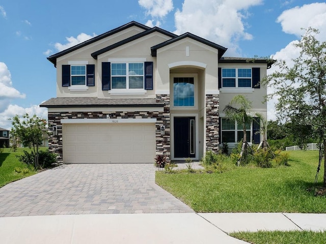 38120 Shale Stone Ct, Zephyrhills, FL 33540 - view of front facade featuring stucco siding, stone siding, decorative driveway, and a front yard