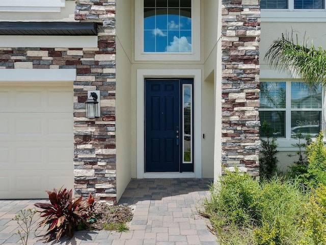 38120 Shale Stone Ct, Zephyrhills, FL 33540 - entrance to property featuring stone siding and a garage