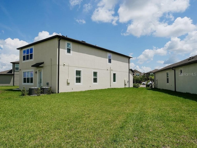 38120 Shale Stone Ct, Zephyrhills, FL 33540 - rear view of property featuring stucco siding and a lawn