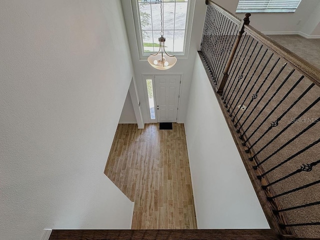 38120 Shale Stone Ct, Zephyrhills, FL 33540 - foyer featuring a high ceiling, stairs, and a chandelier