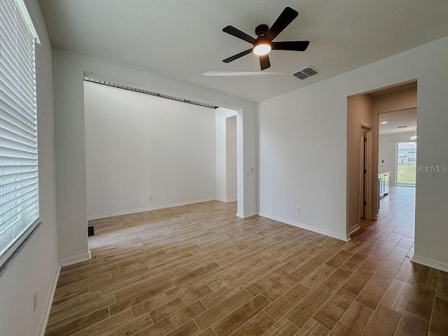 38120 Shale Stone Ct, Zephyrhills, FL 33540 - empty room featuring a ceiling fan and wood finished floors