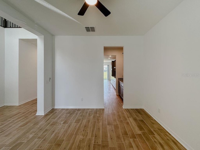 38120 Shale Stone Ct, Zephyrhills, FL 33540 - empty room with light wood finished floors and ceiling fan