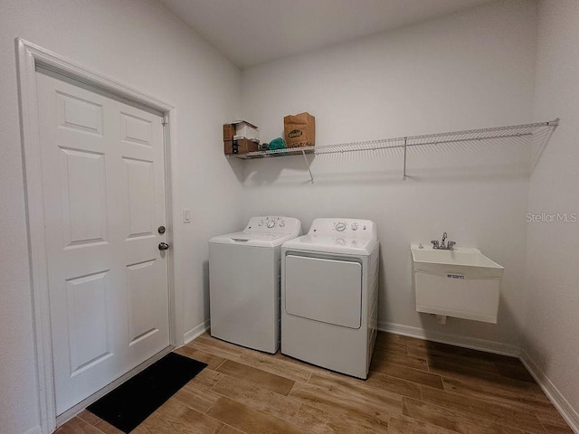 38120 Shale Stone Ct, Zephyrhills, FL 33540 - washroom with washing machine and dryer and light wood finished floors
