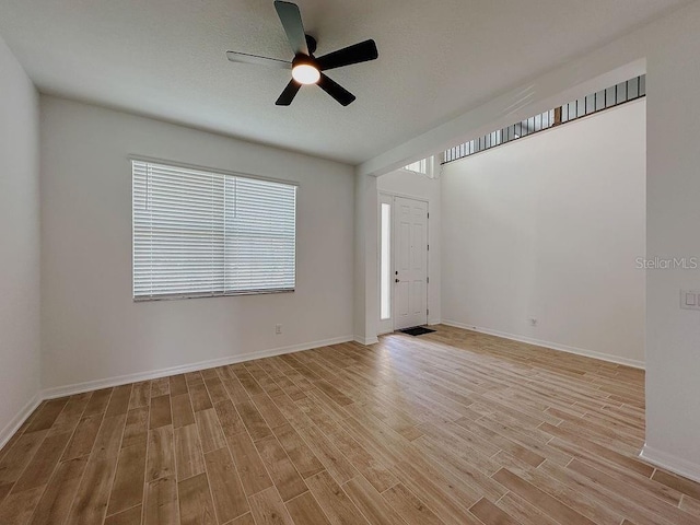 38120 Shale Stone Ct, Zephyrhills, FL 33540 - unfurnished room featuring light wood-style flooring and ceiling fan